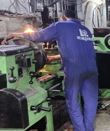 A Leakless machinist working at a lathe in the Malad works